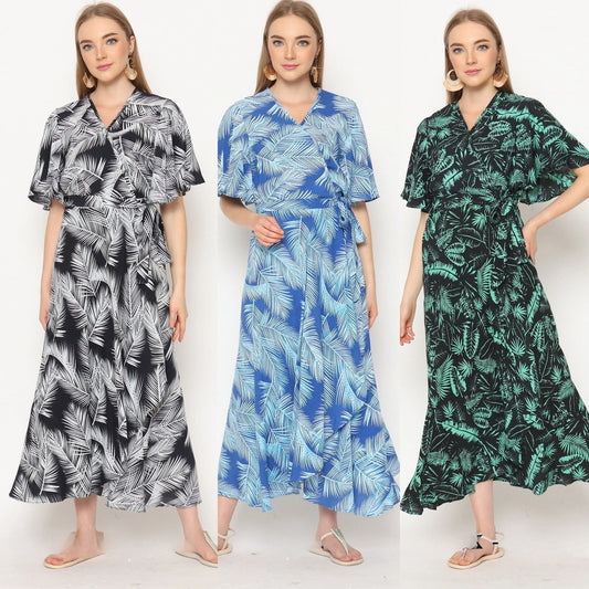 Three women wearing ankle-length wrap dresses with white leaf patterns. The dresses, in black, blue, and green shades, feature a flowy design with short sleeves. Each woman stands with a relaxed pose and neutral expression, perfectly showcasing these stylish wrap dresses for women.